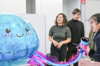 Students with Ellie the Jellyfish installation