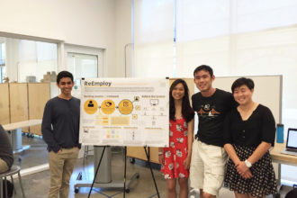 team of four students with project poster