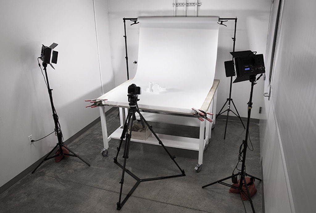 Photo studio with camera, backdrop, lighting